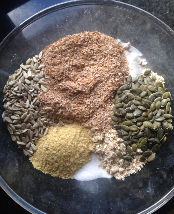 All the dry ingredients in a bowl: flour, wheat bran, wheat germ, salt, bicarbonate of soda and seeds.